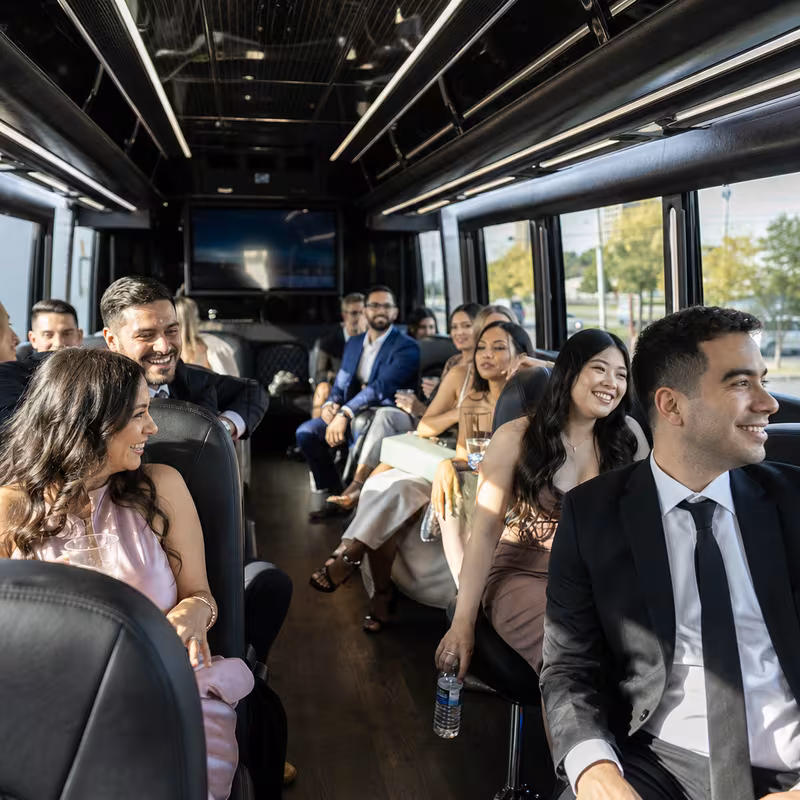 Wedding guests seated inside a Elizabeth party bus