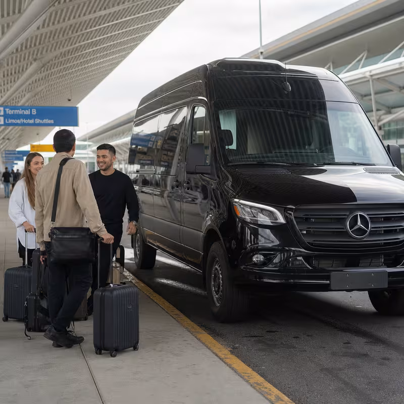 Group boarding a white charter bus for Airport Transportation transportation in Elizabeth