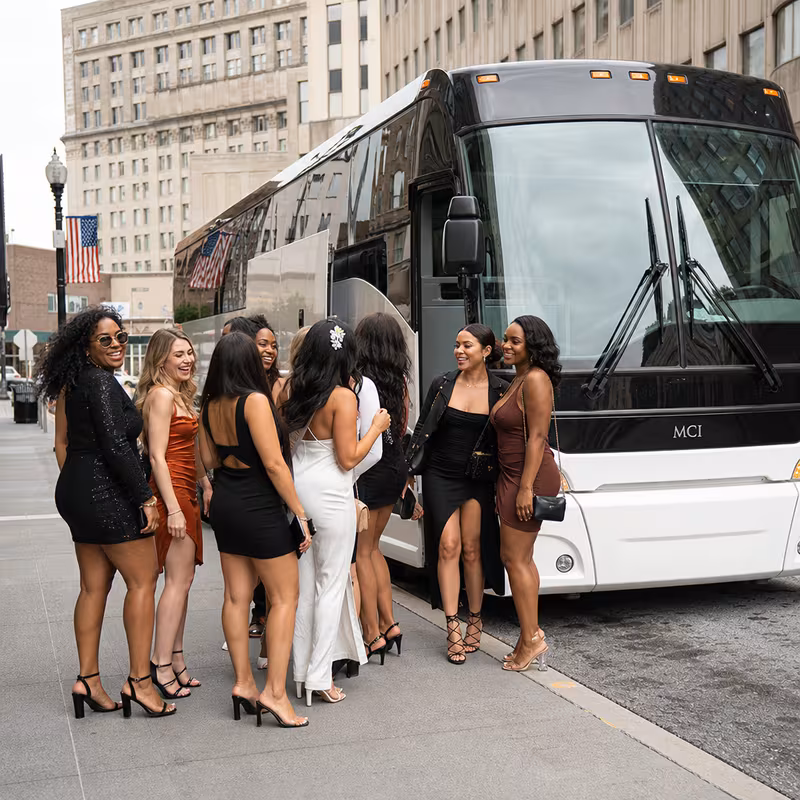 Passengers loading luggage while boarding an Elizabeth group shuttle