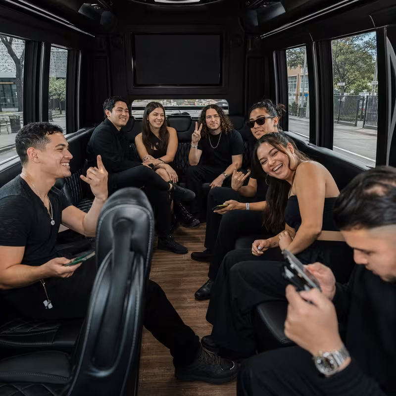 Group boarding a white charter bus for Concert Transportation transportation in Elizabeth