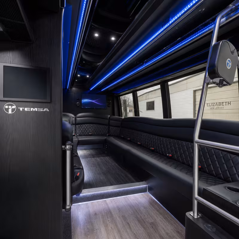 Party bus interior with wraparound leather seating and LED lighting in Elizabeth