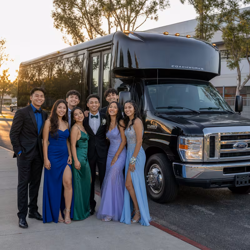 Group boarding a white charter bus for Prom & Homecoming Transportation transportation in Elizabeth