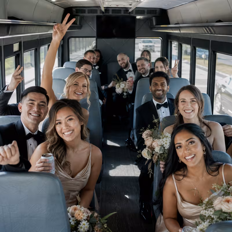 Group boarding a white charter bus for Wedding Transportation transportation in Elizabeth