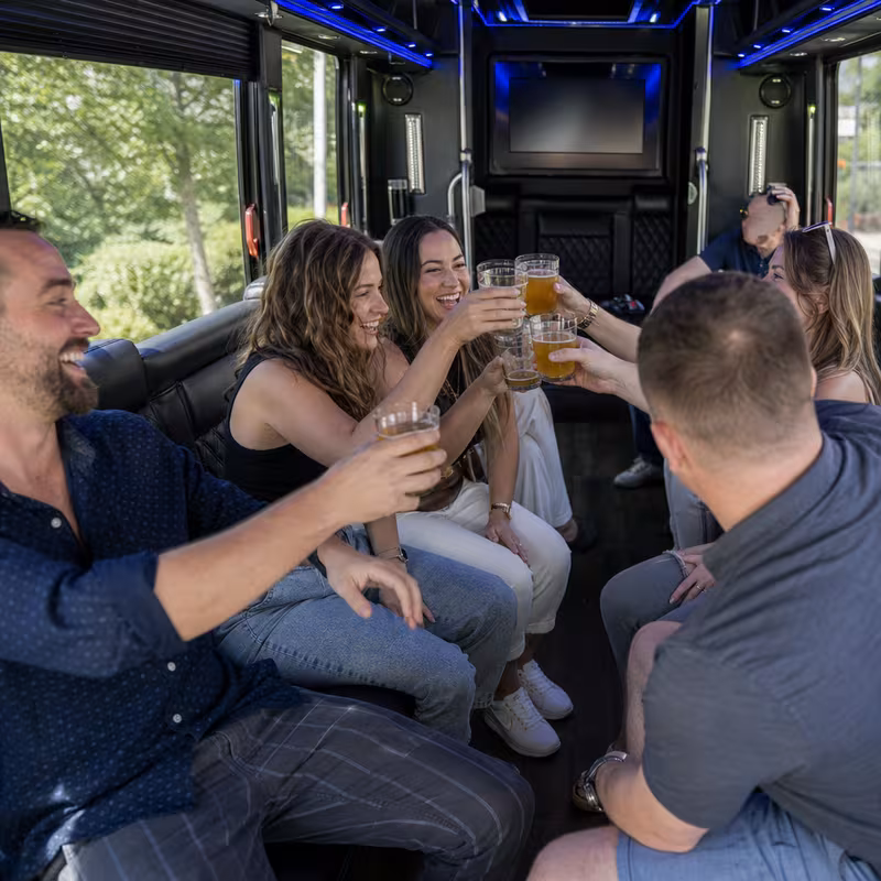 Group boarding a white charter bus for Winery & Brewery Tour Transportation transportation in Elizabeth